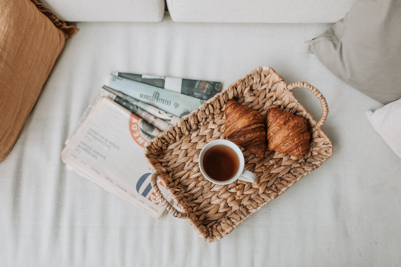 White Ceramic Mug on Brown Woven Tray with Brown Breads